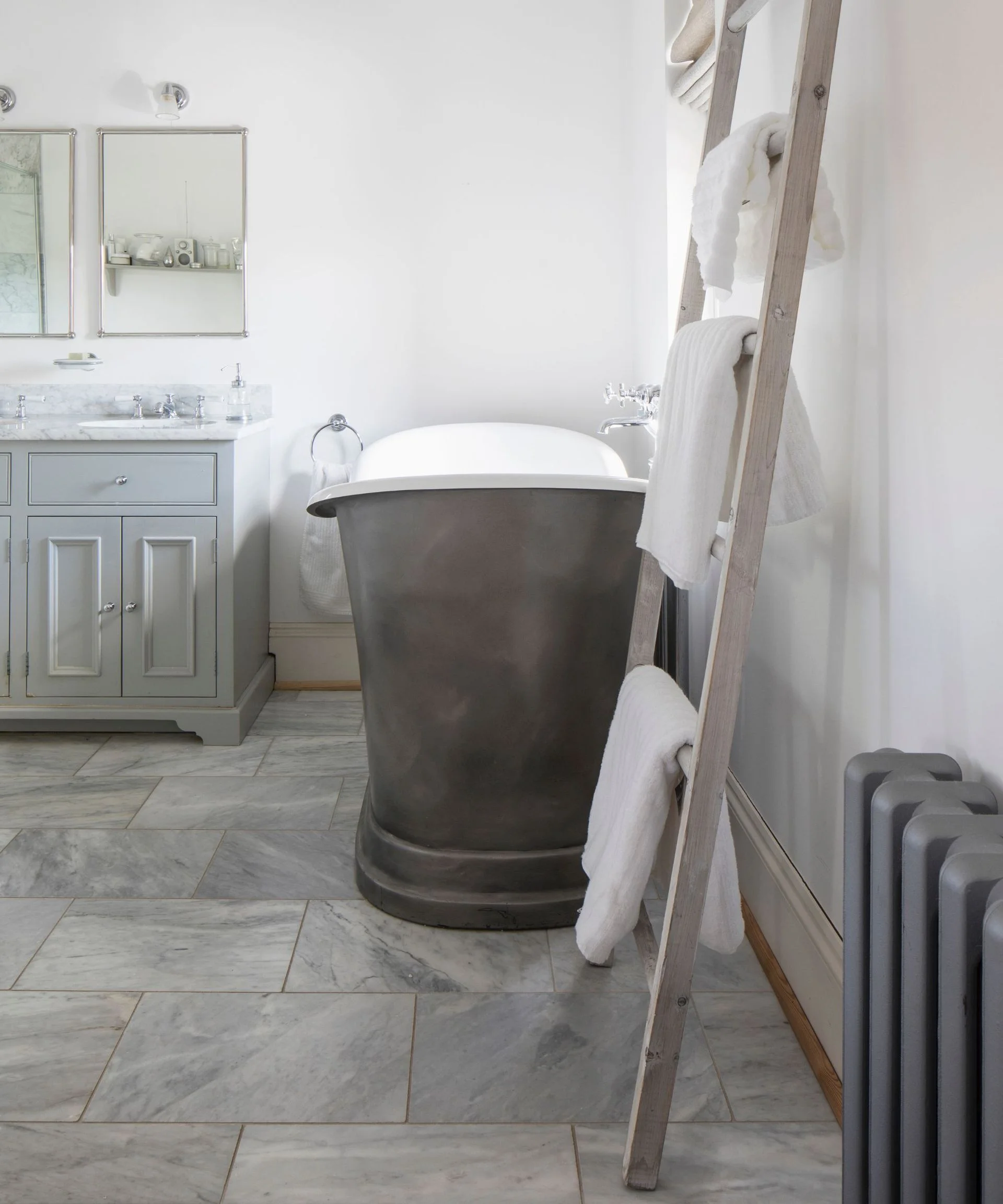 Freestanding bath on grey flagstone