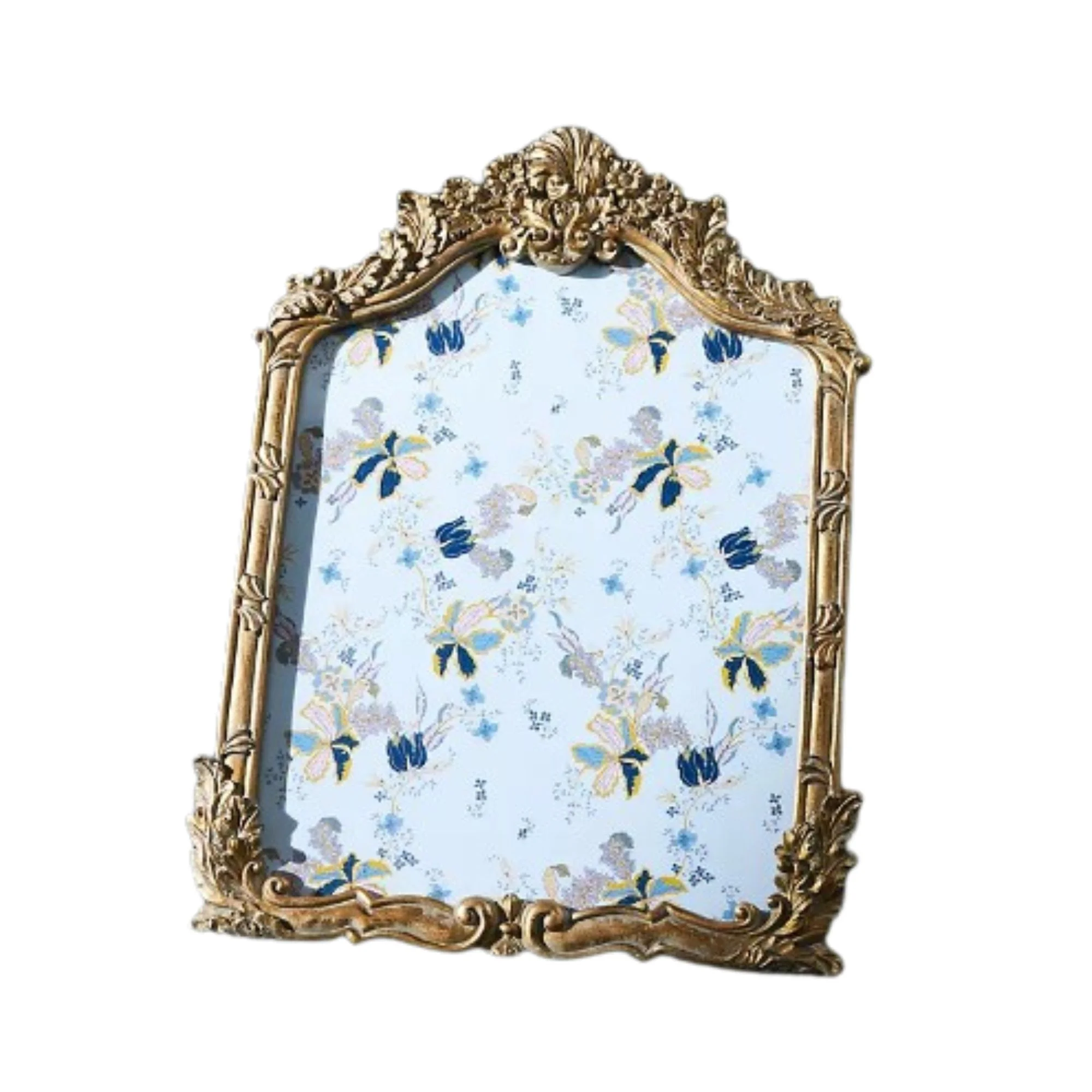 A brass vintage-style frame with a blue floral print