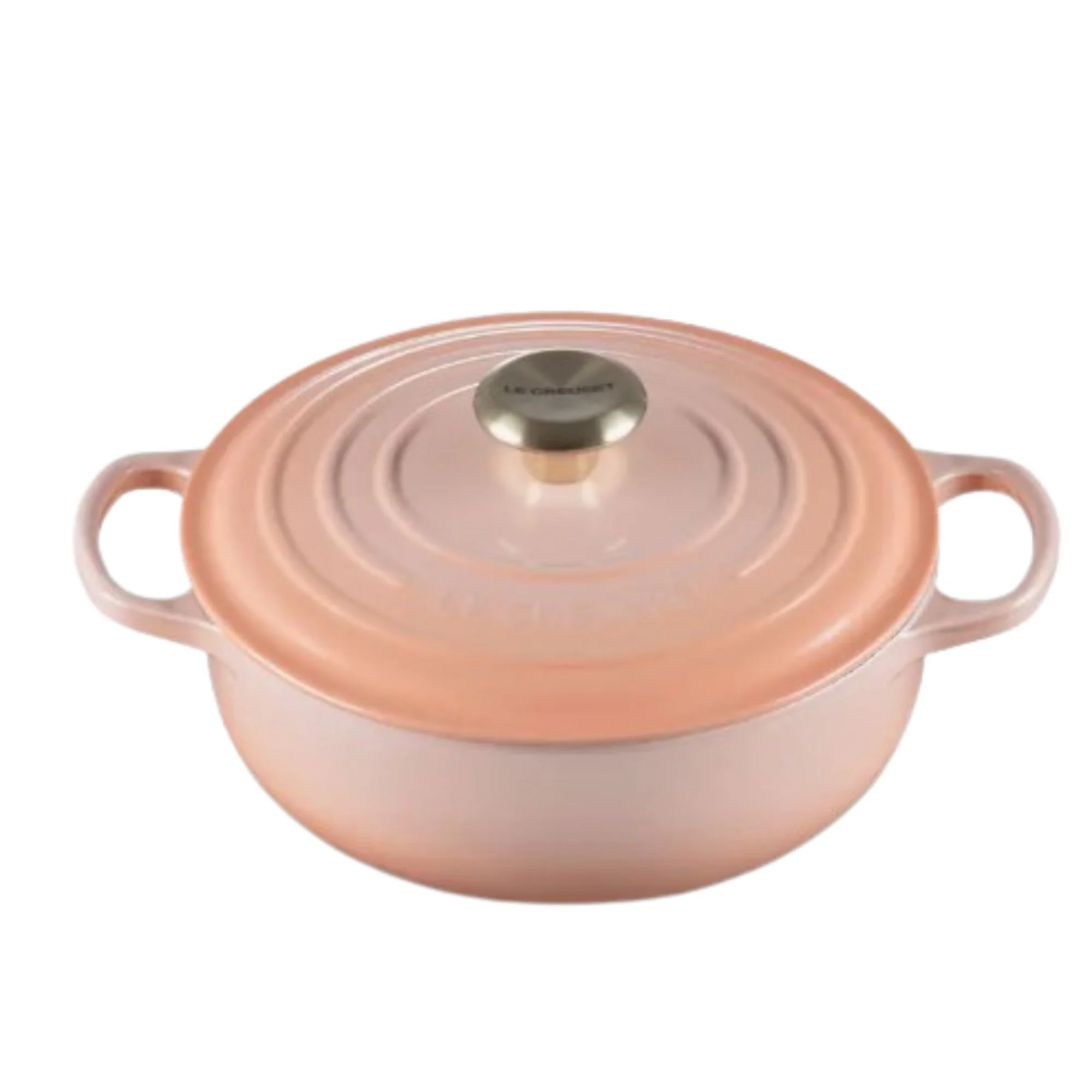 A round peach pink Le Creuset Dutch oven