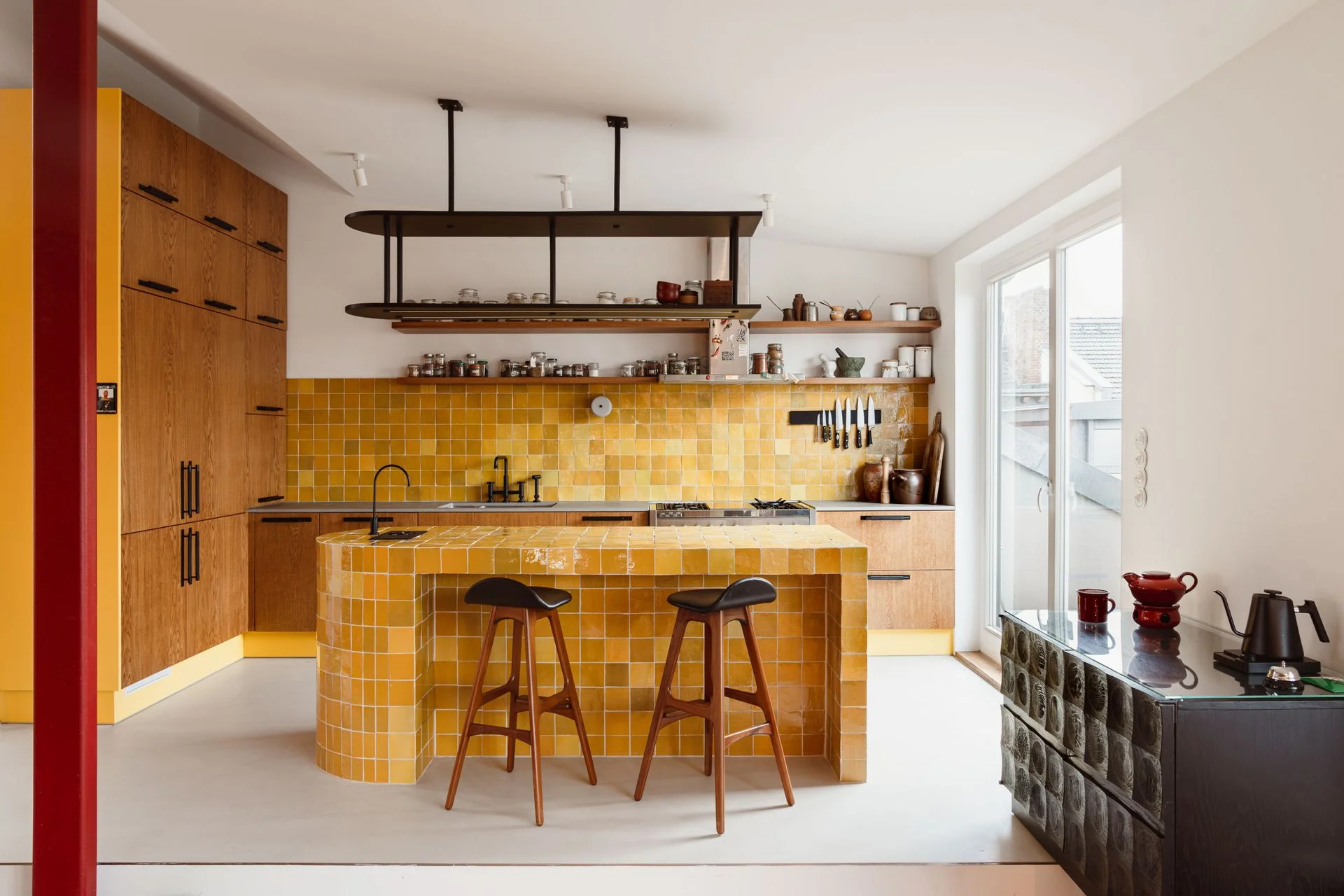 A mustard yellow kitchen with wood cabinetry