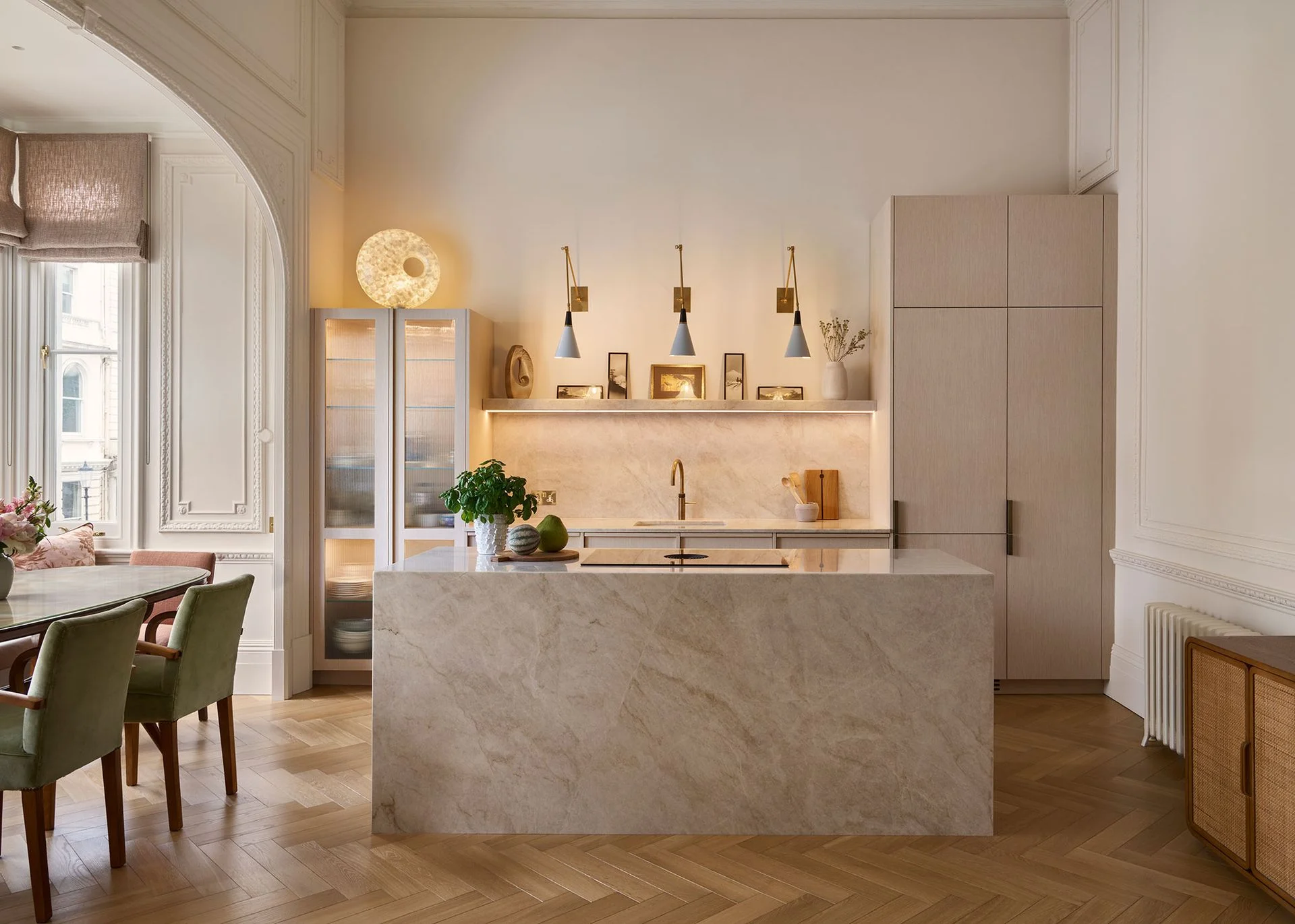 neutral stone kitchen diner with wall sconces