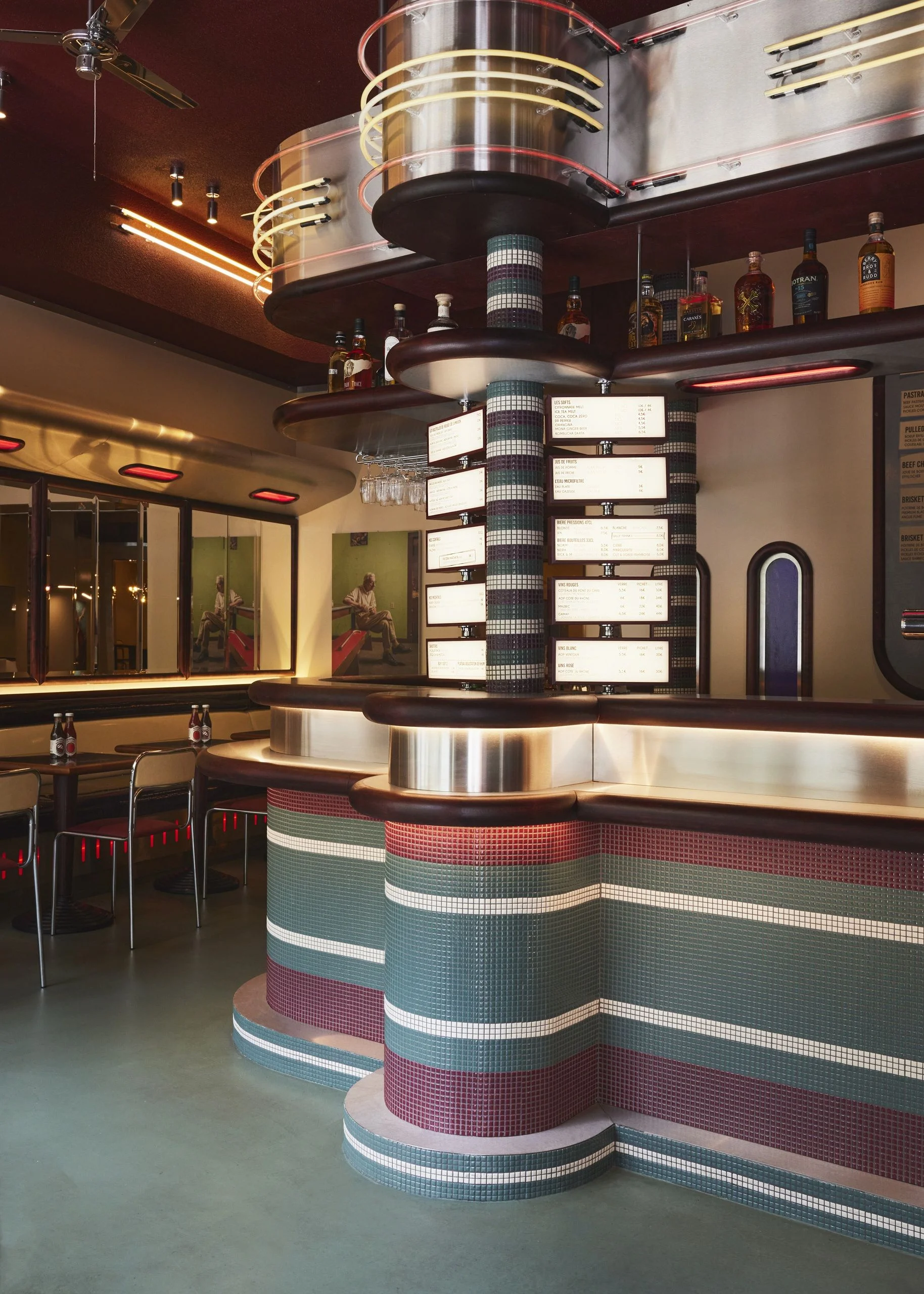 the interiors of a diner in paris with blue and red color palettes and retro style