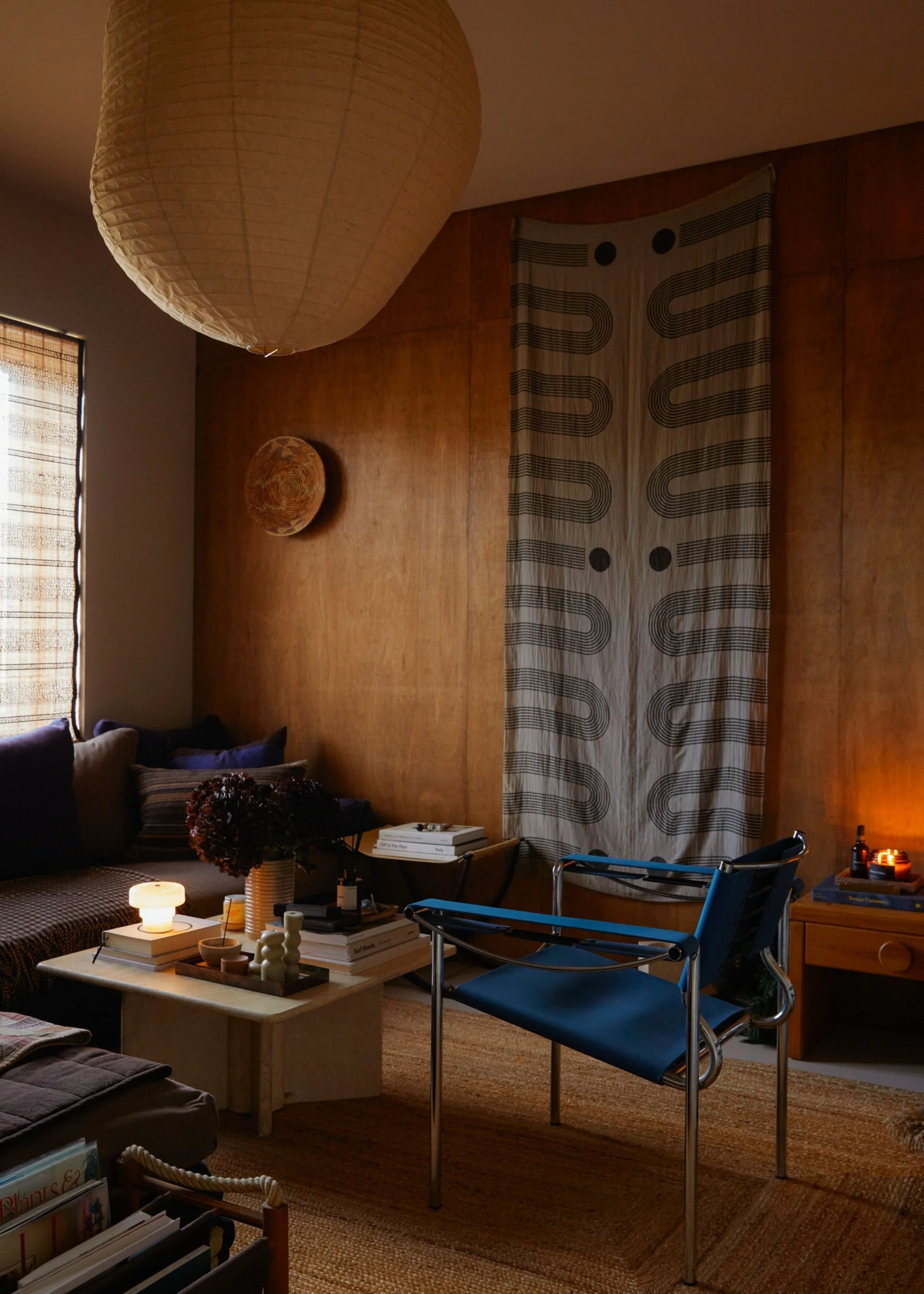 A living room with a paper pendant lamp and calming decor.