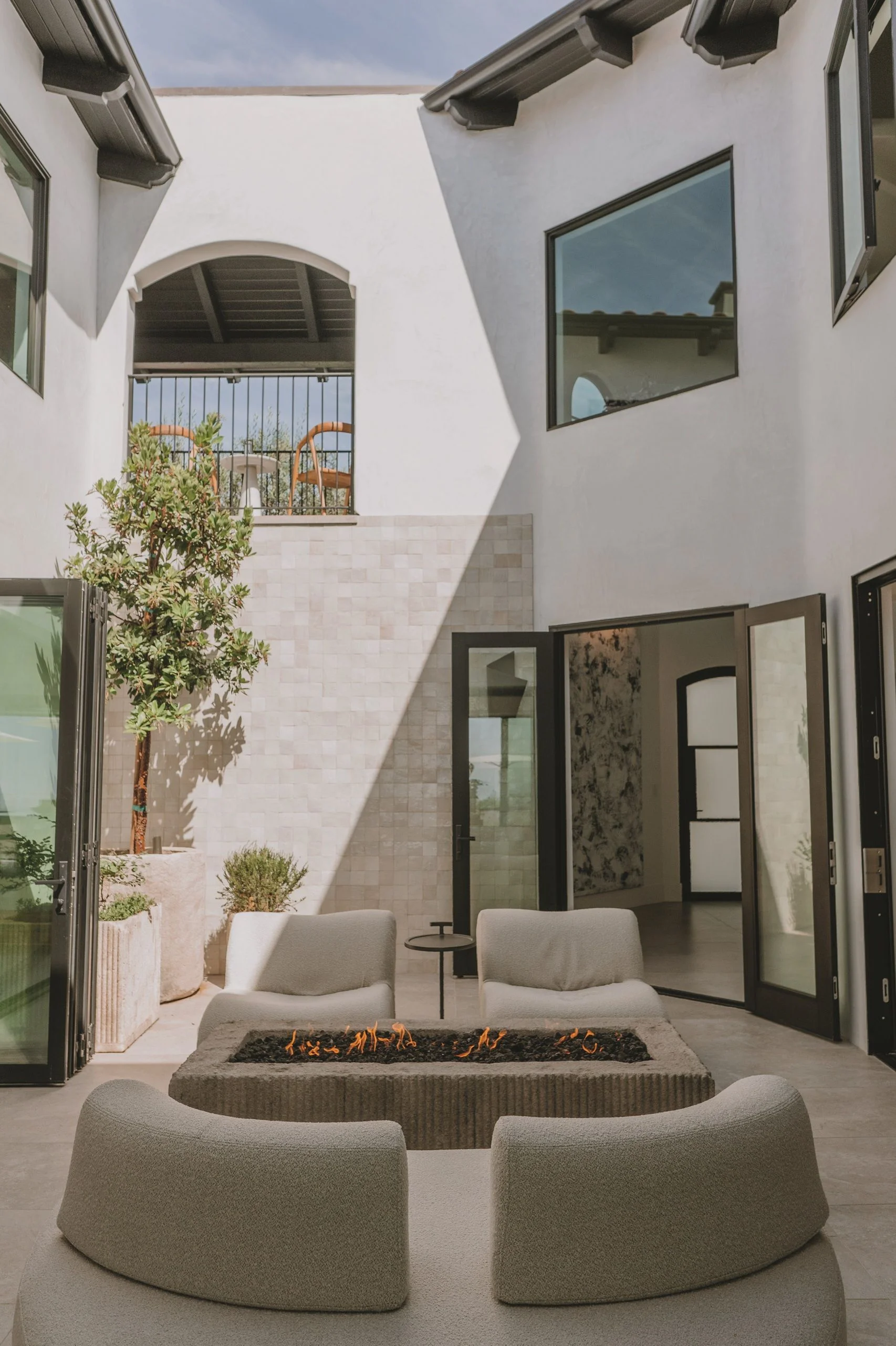 A minimalist outdoor firepit in a contemporary courtyard