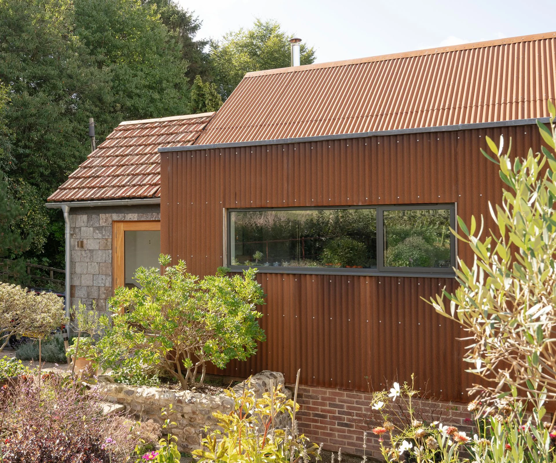 modern corten steel and stone clad self build