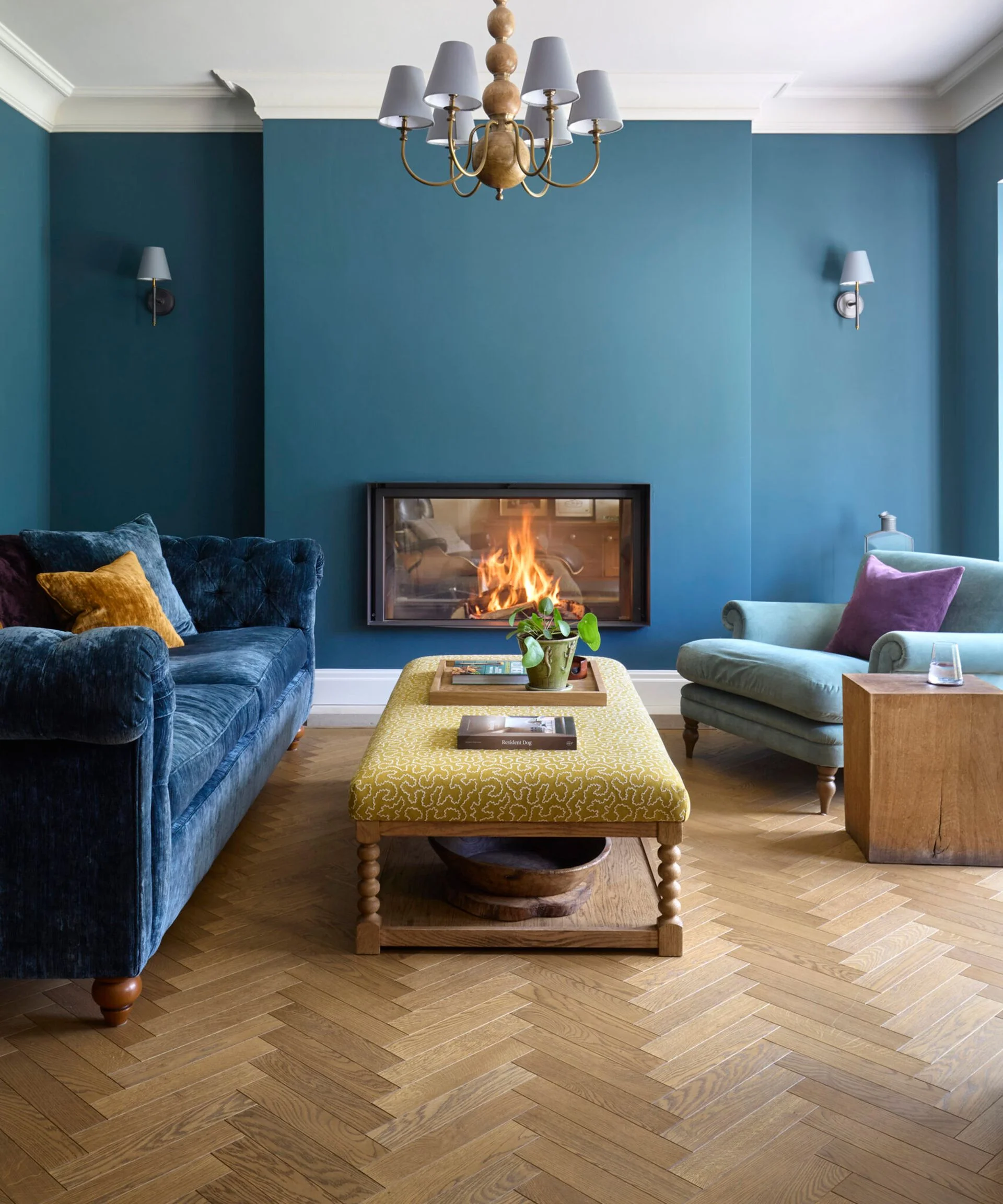 blue living room with herringbone engineered flooring