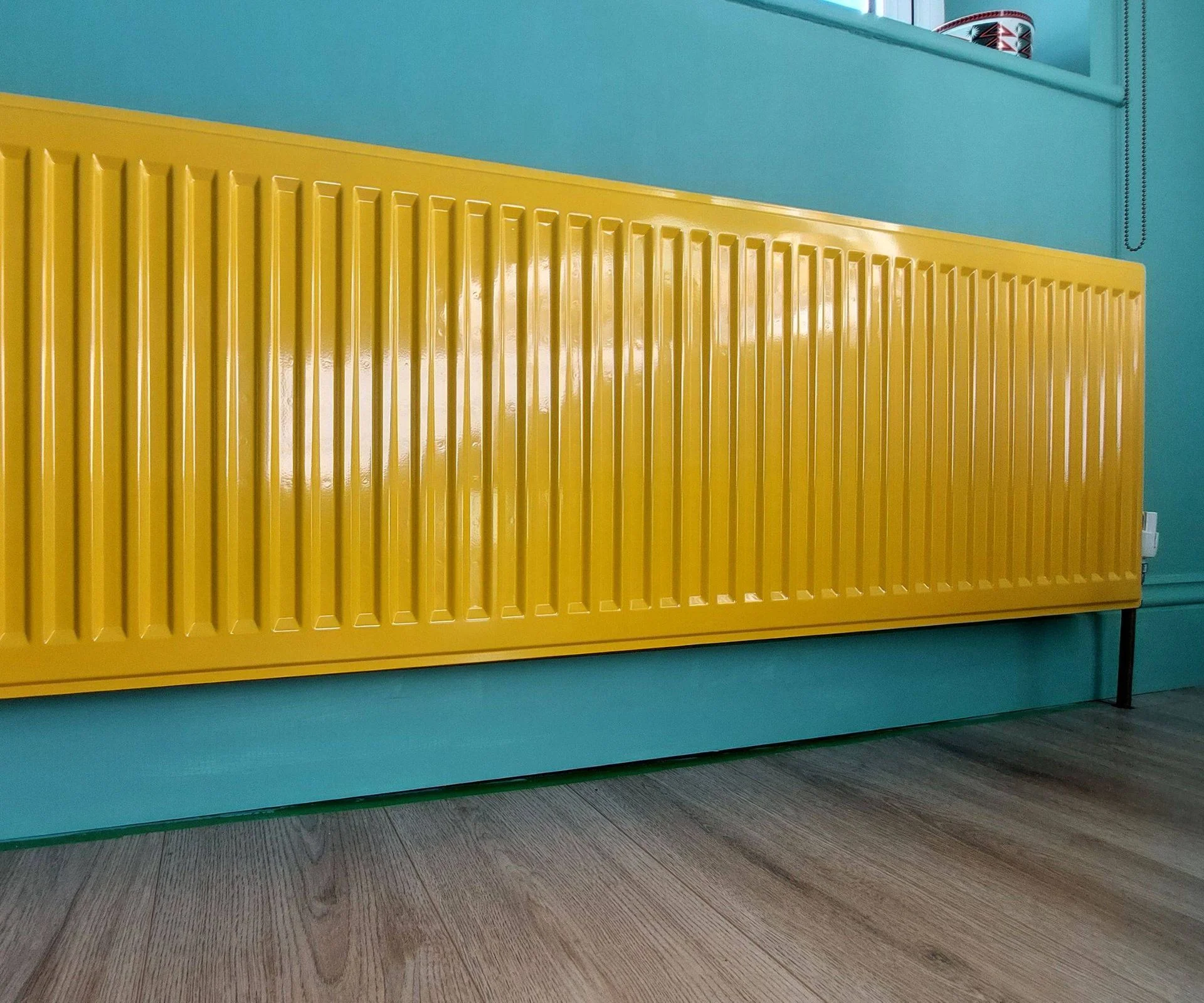 yellow radiator on blue wall