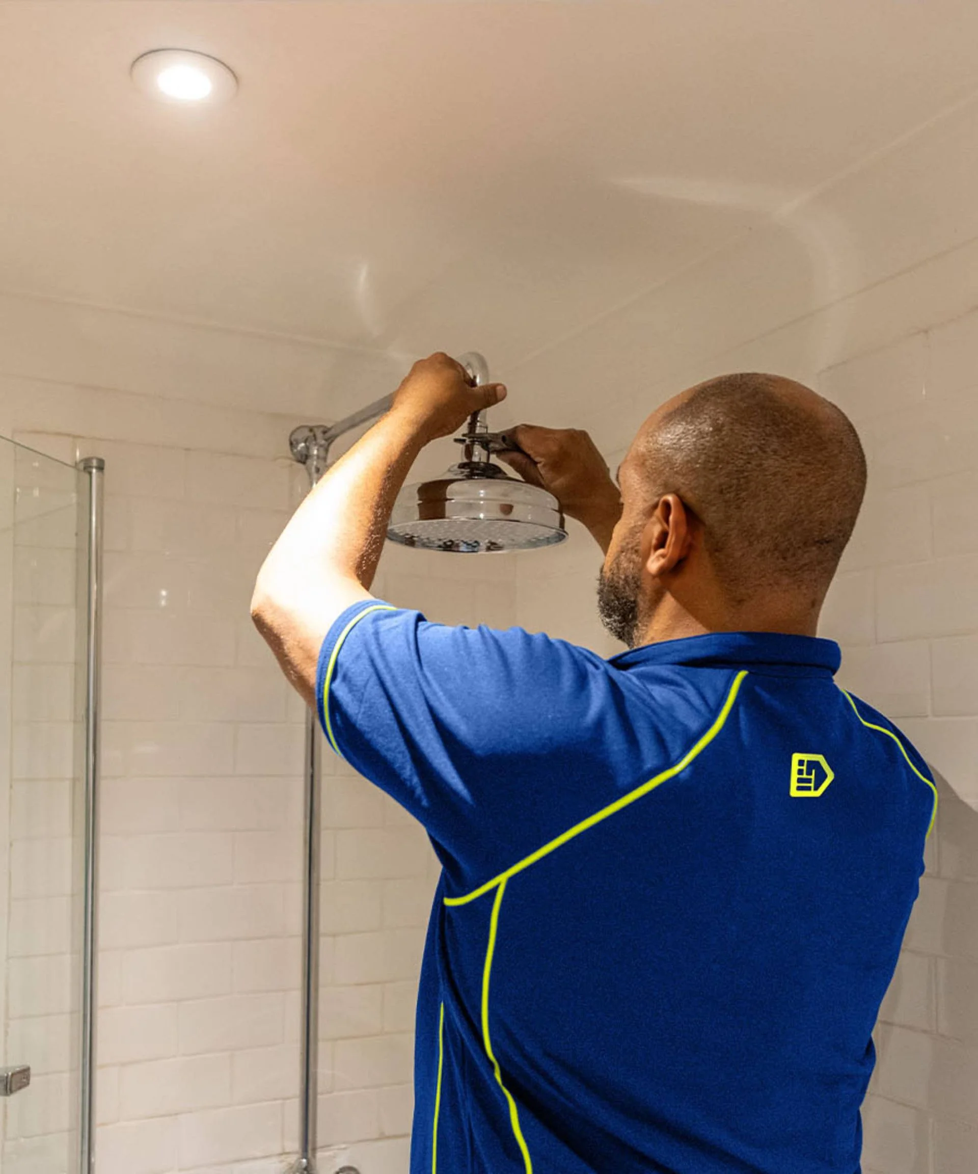 Engineer fixing a new shower head