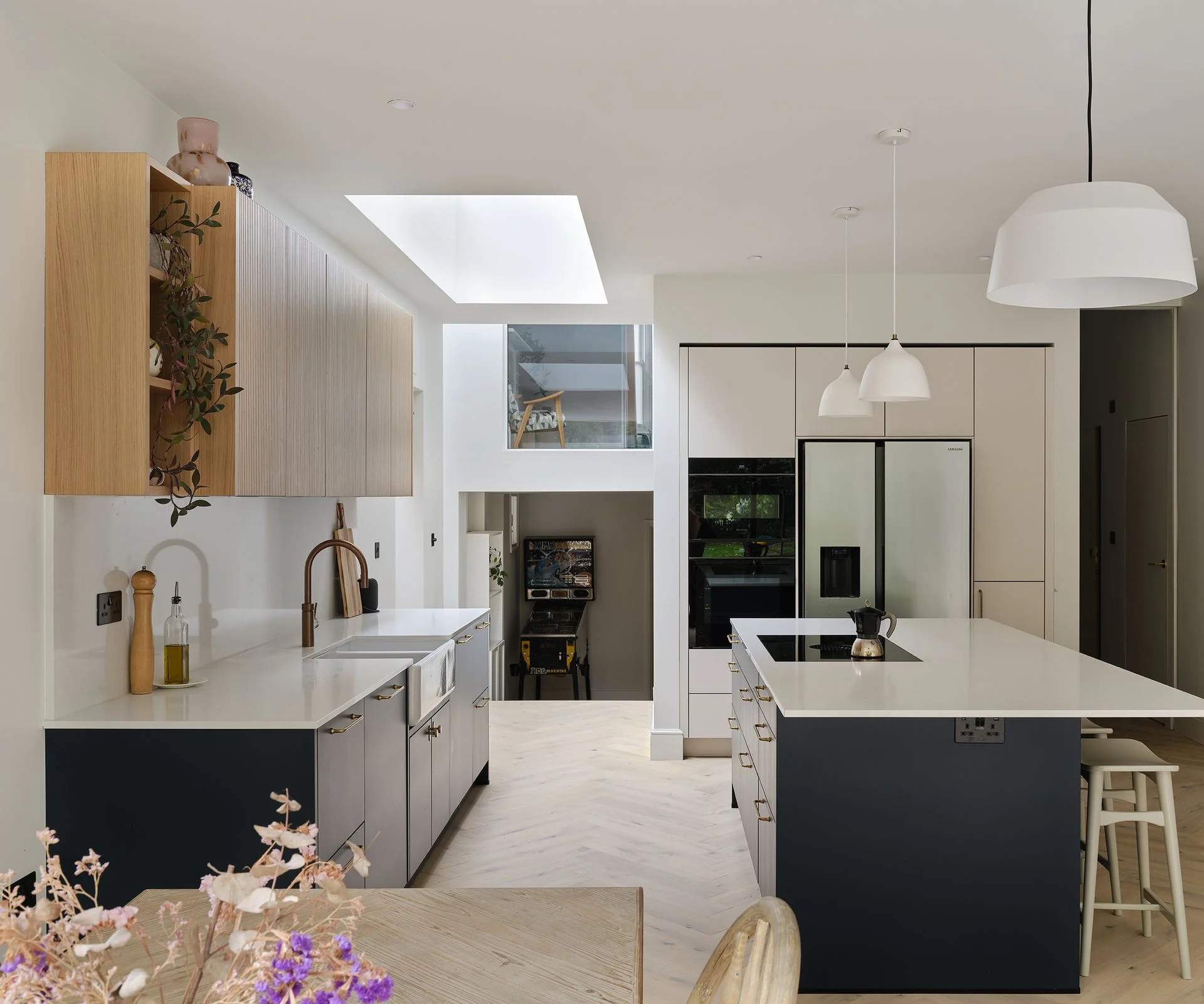 modern blue and white kitchen extension with roof lantern and double height spaces