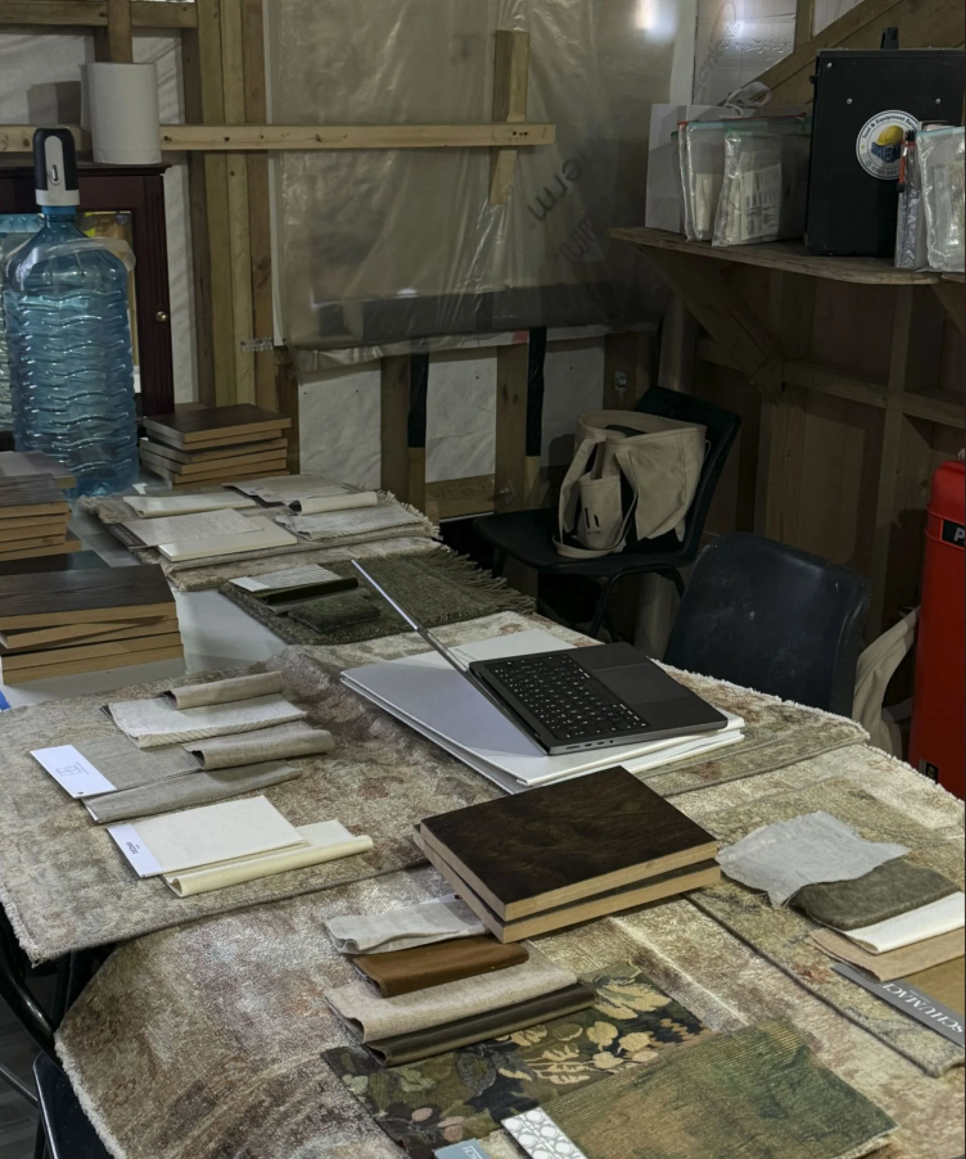 Interior designer's work station covered in paperwork and material samples