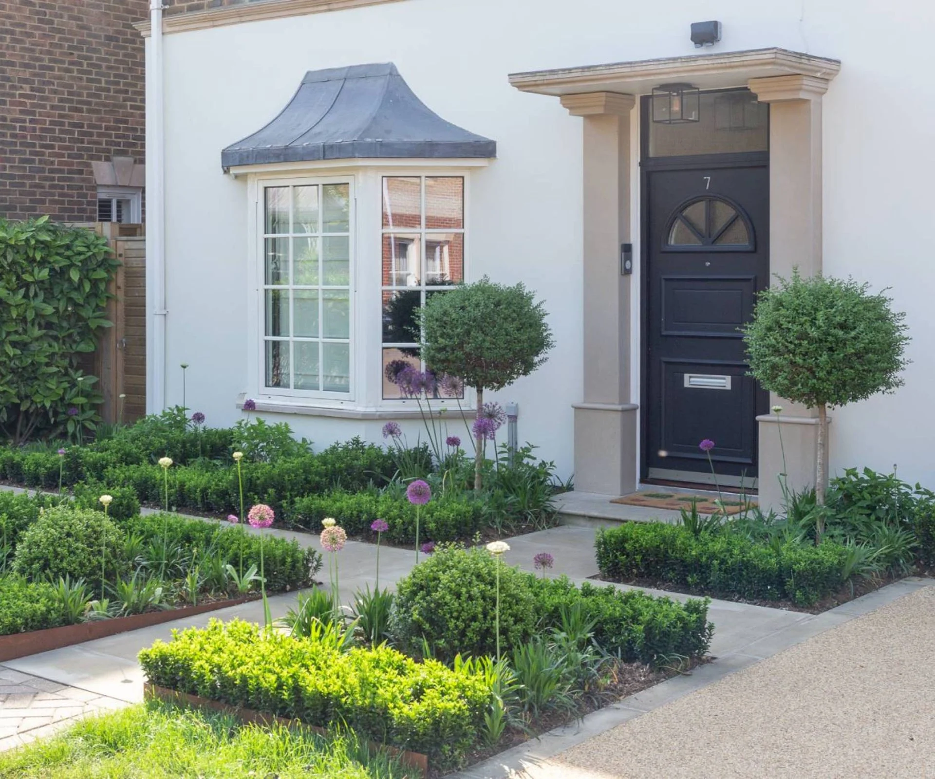 Small front garden with topiary and low hedging
