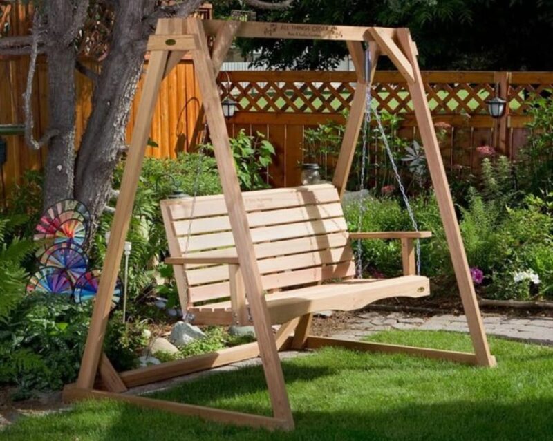 wooden swing in the shade of trees